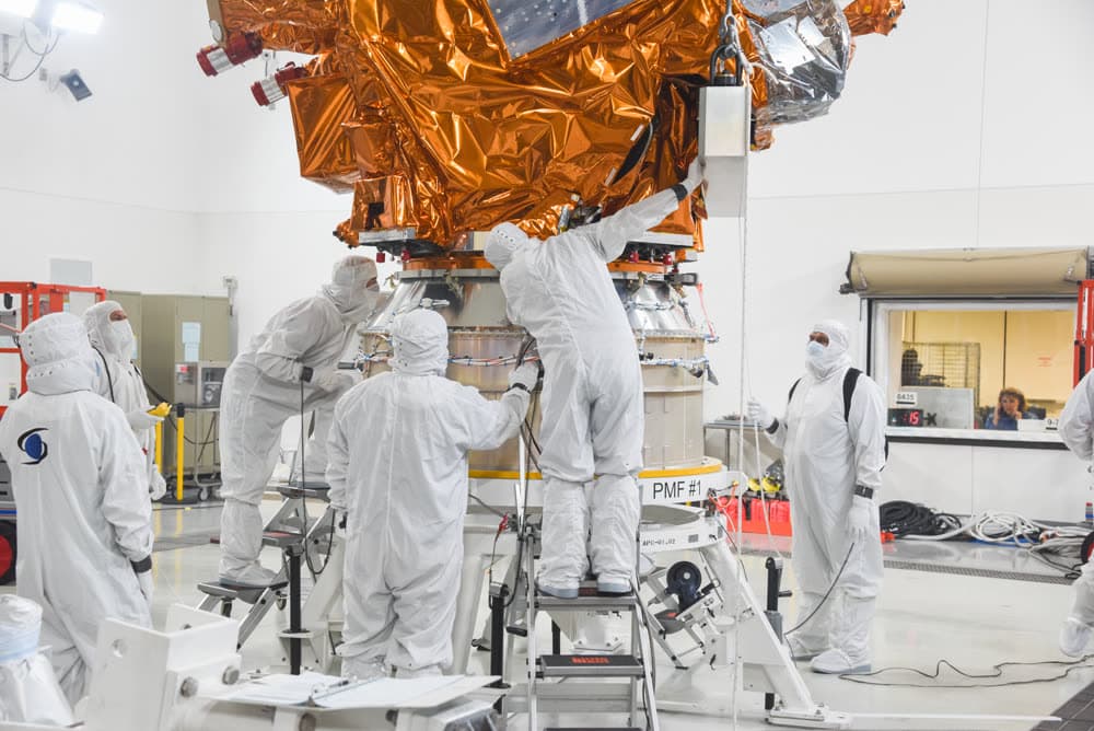 Technicians in cleanroom suits with the JPSS-2 satellite